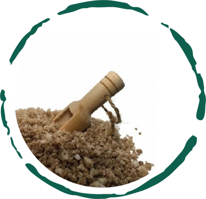 Bath and foot soak granules with small wooden scoop, close-up on brown salt mix