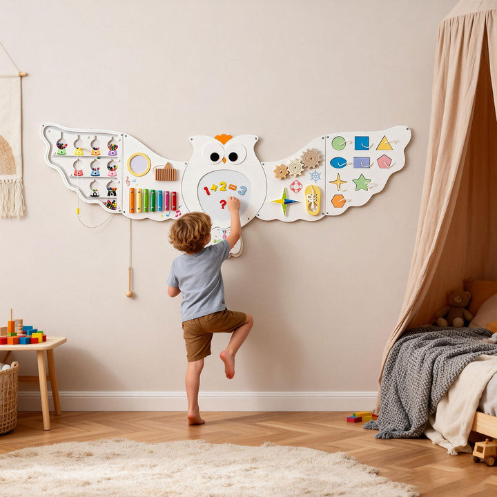 Owl-shaped toddler busy board learning panel with colorful numbers, gears, and shapes