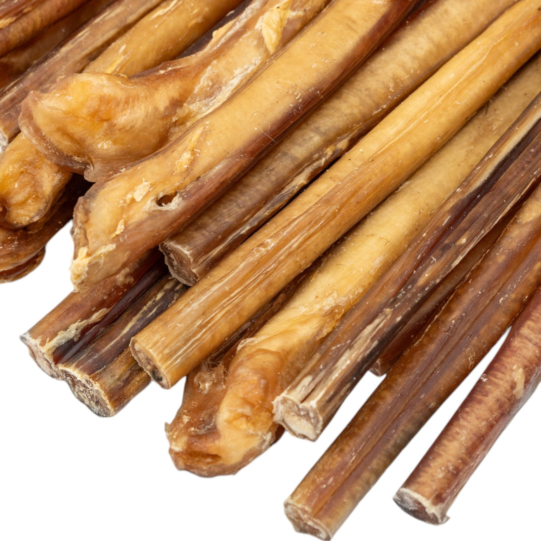 Close-up of jumbo beef bully sticks, beige-brown meaty chew logs