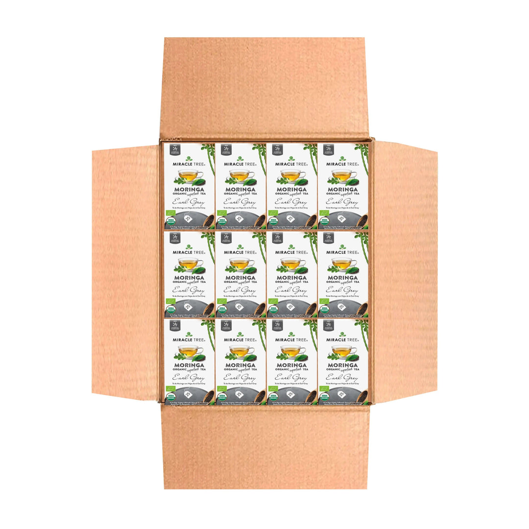 Bulk organic moringa Earl Grey tea cartons in a cardboard shipping box, front view