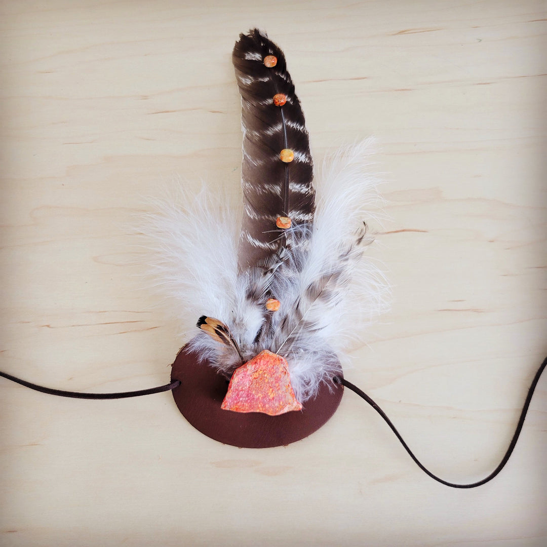 Feather and leather hat band with orange stone accent