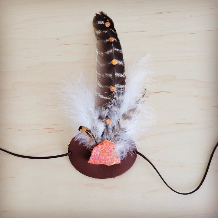 Feather and leather hat band with orange stone accent