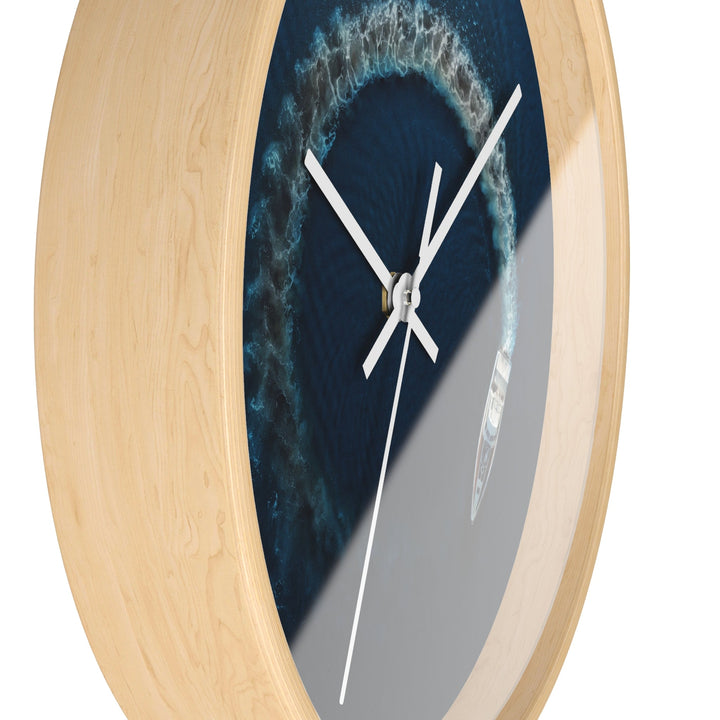 Round wall clock close-up side view, blue nautical face, wooden rim, white hands