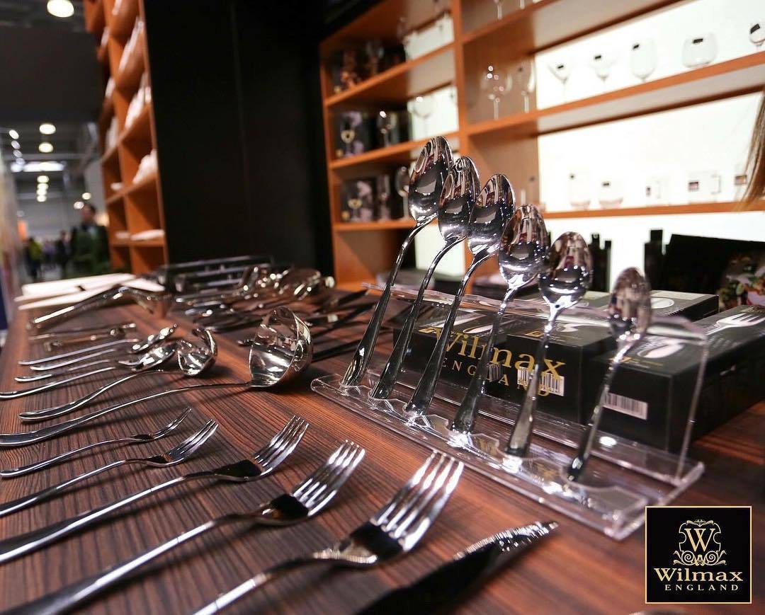 Polished stainless steel soup ladles set on countertop display