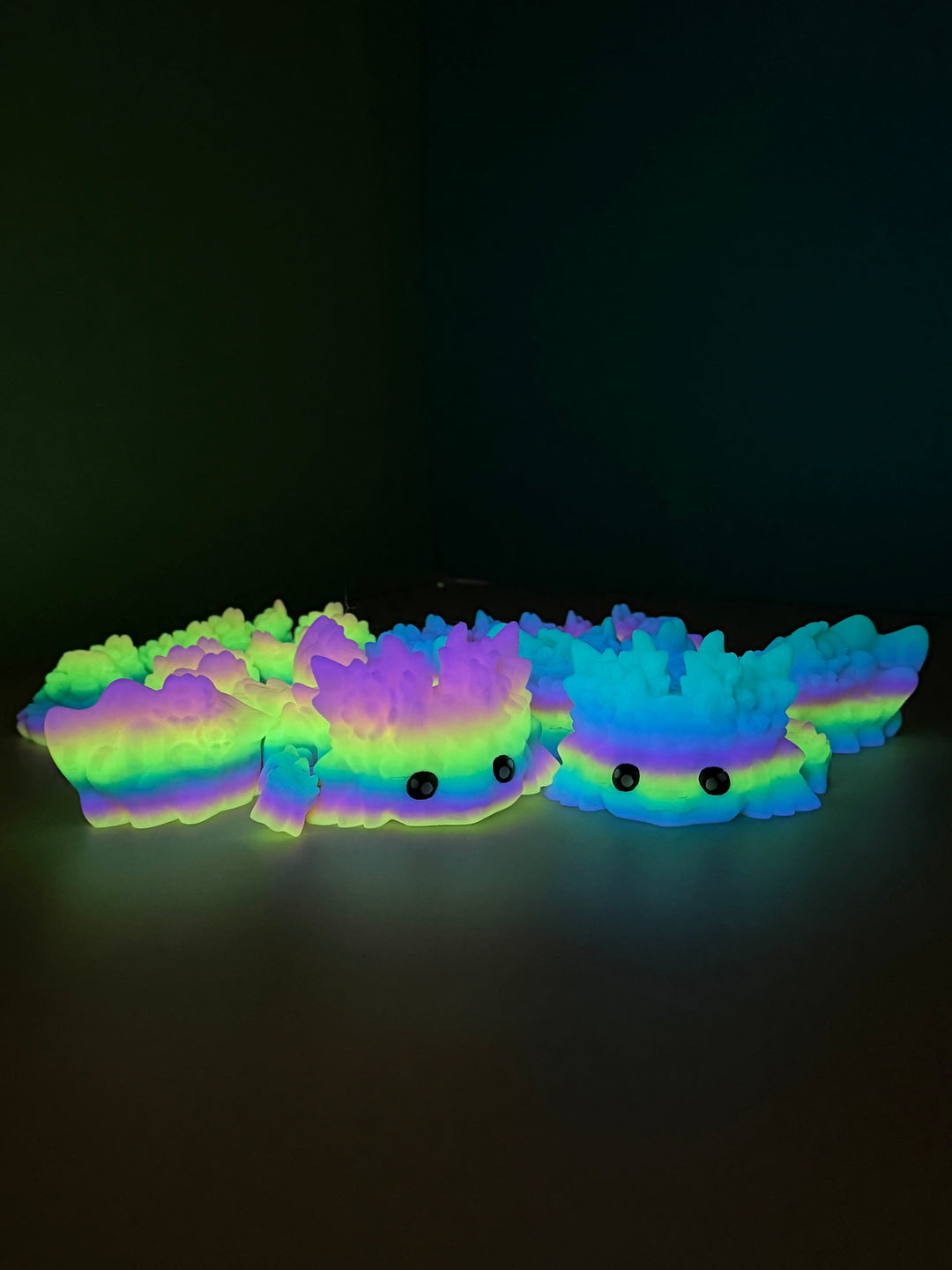 Neon rainbow axolotl dragon plush, glowing multicolor body with two eye faces