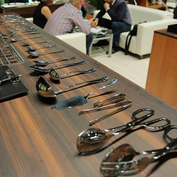 Table display of polished ice cream spoons, 5.75 in stainless set