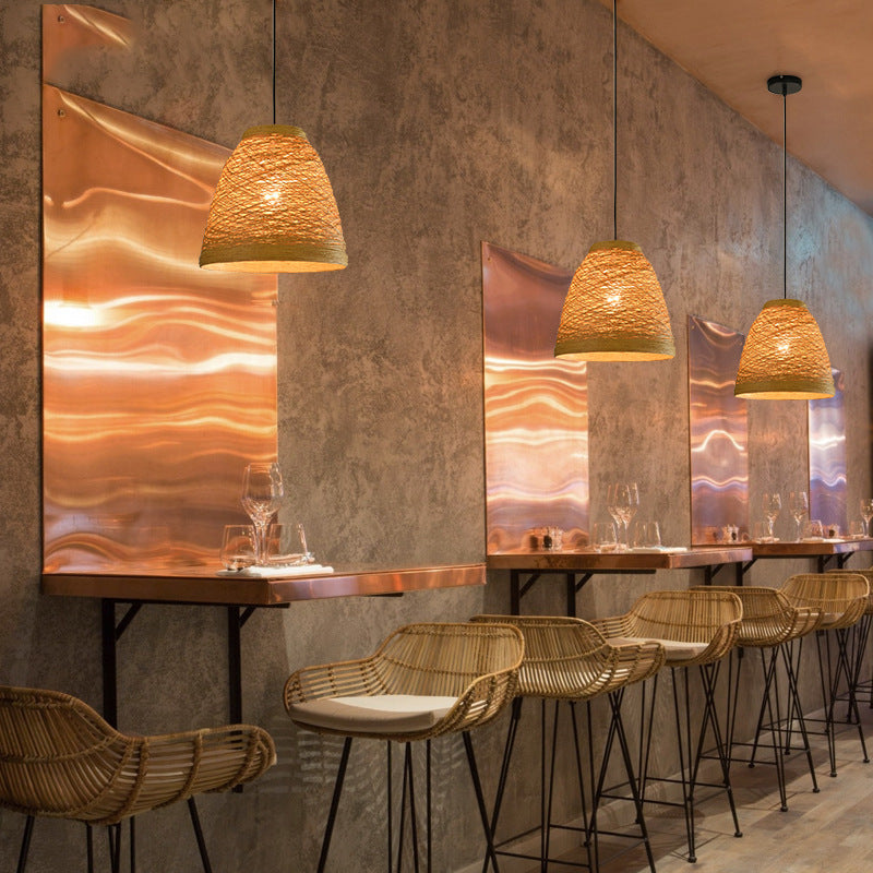 Woven rattan pendant lamps with warm amber bell shades, hanging from the ceiling