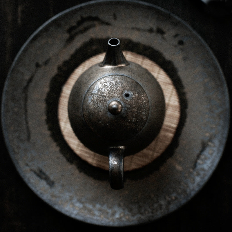Ceramic dark speckled tea kettle body with knob and central opening