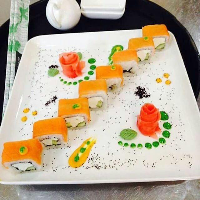 White square serving dish with assorted appetizers and colorful garnish