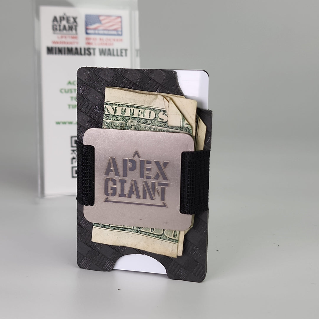 Minimalist dark wallet with elastic band holding several folded bills in card slots