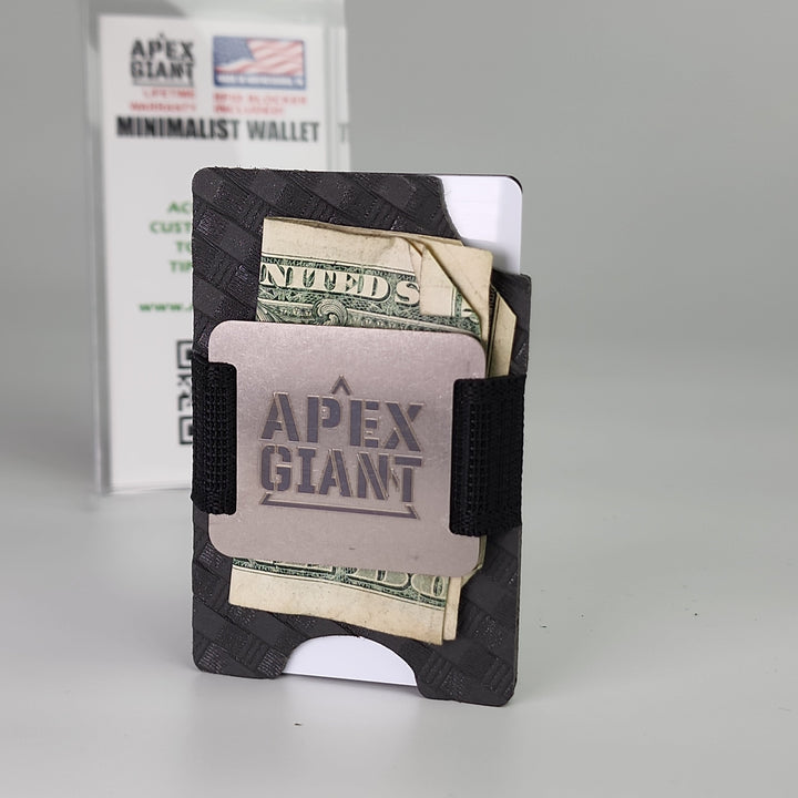 Minimalist dark wallet with elastic band holding several folded bills in card slots