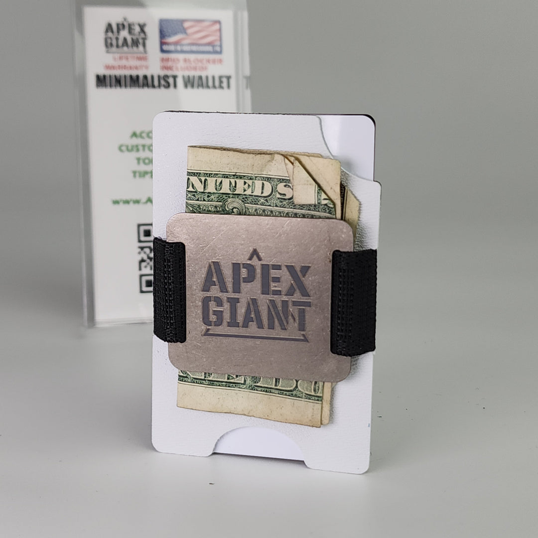 White minimalist wallet with black elastic strap, bills and cards visible inside.