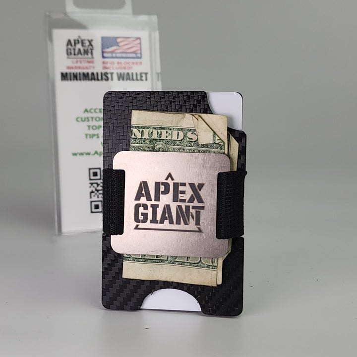 Black carbon fiber minimalist wallet holding cash and cards with elastic band