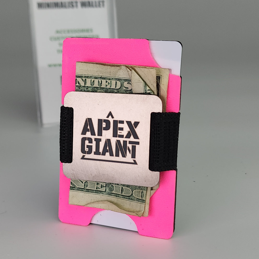 Hot pink minimalist wallet holding cash and cards with black elastic bands