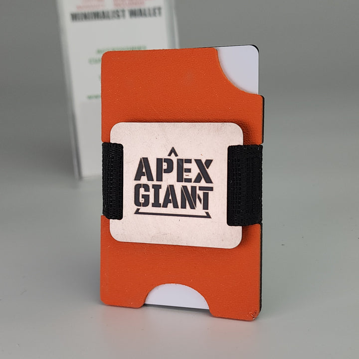 Hunter orange minimalist wallet with black elastic bands and APEX GIANT logo