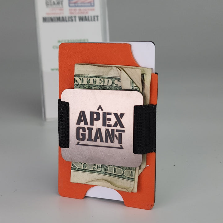 Hunter orange minimalist wallet holding cash, with black elastic bands and APEX GIANT logo