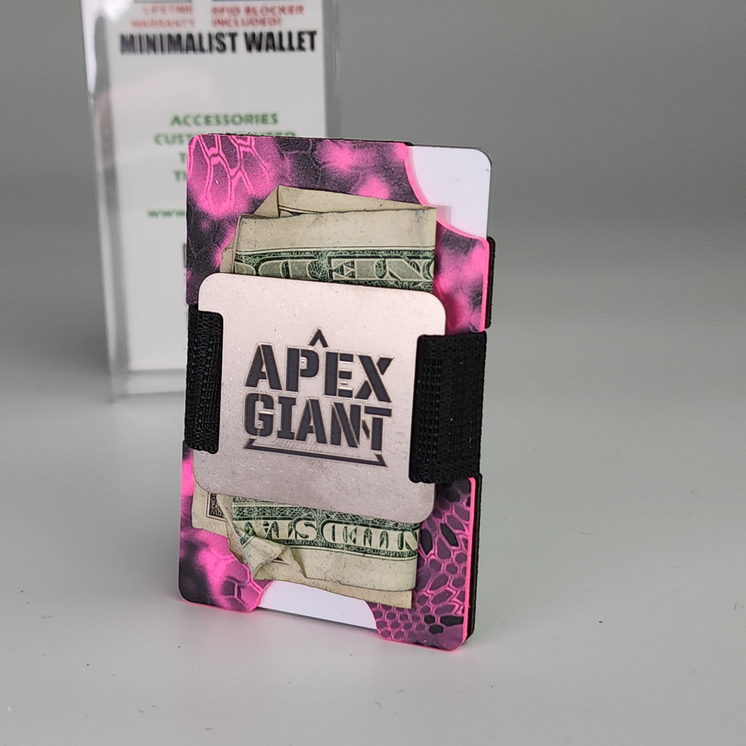 Hot pink camo minimalist wallet holding cash and cards with black elastic straps