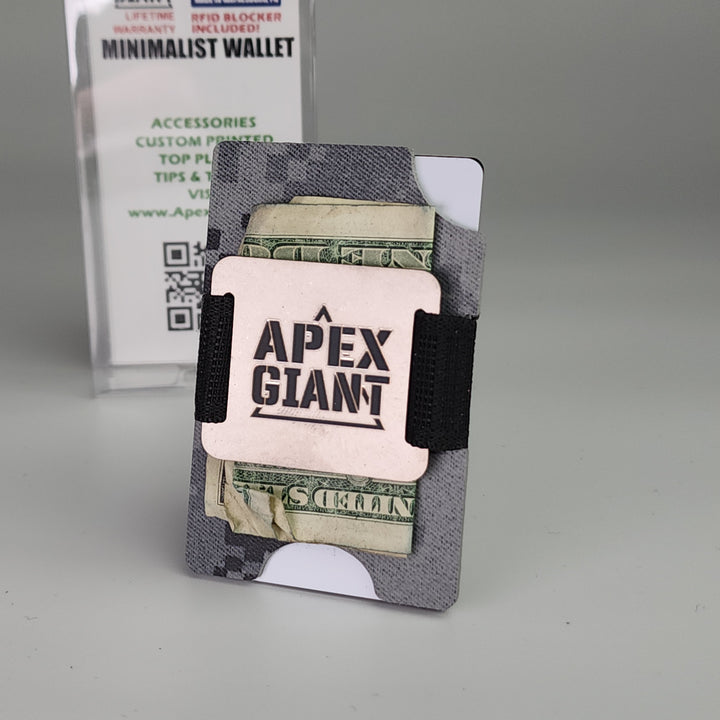 Minimalist wallet in dark digital camo with black elastic strap holding cash and cards