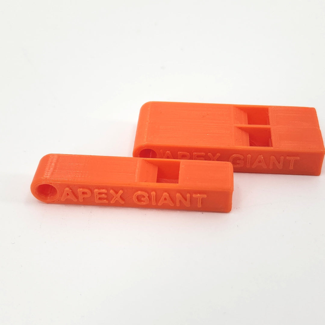 Close-up orange plastic emergency whistles with APEX GIANT engraving, two pieces
