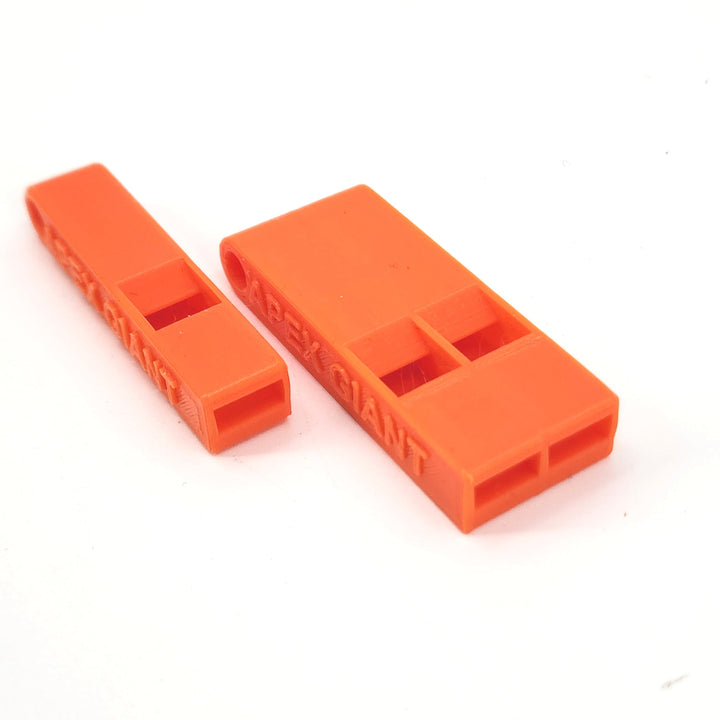 Orange plastic emergency whistle pair with rectangular mouthpiece openings and APEX GIANT