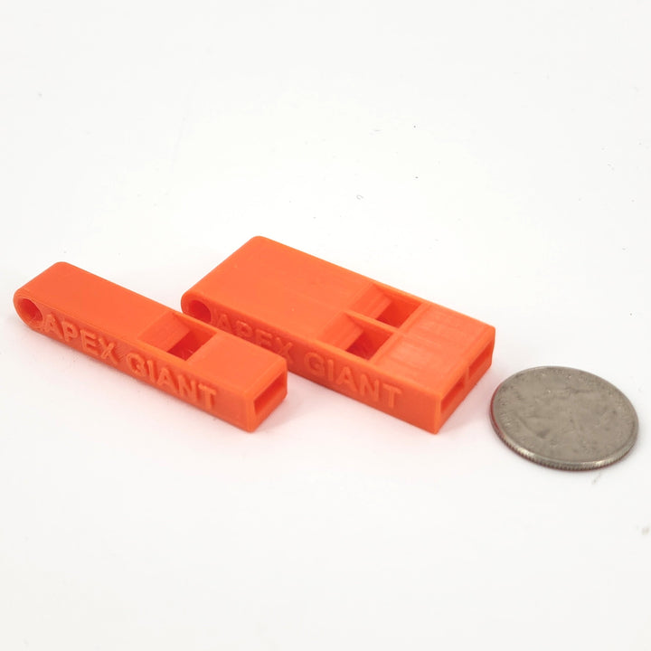 Orange plastic emergency whistle pair next to coin, APEX GIANT molded on each
