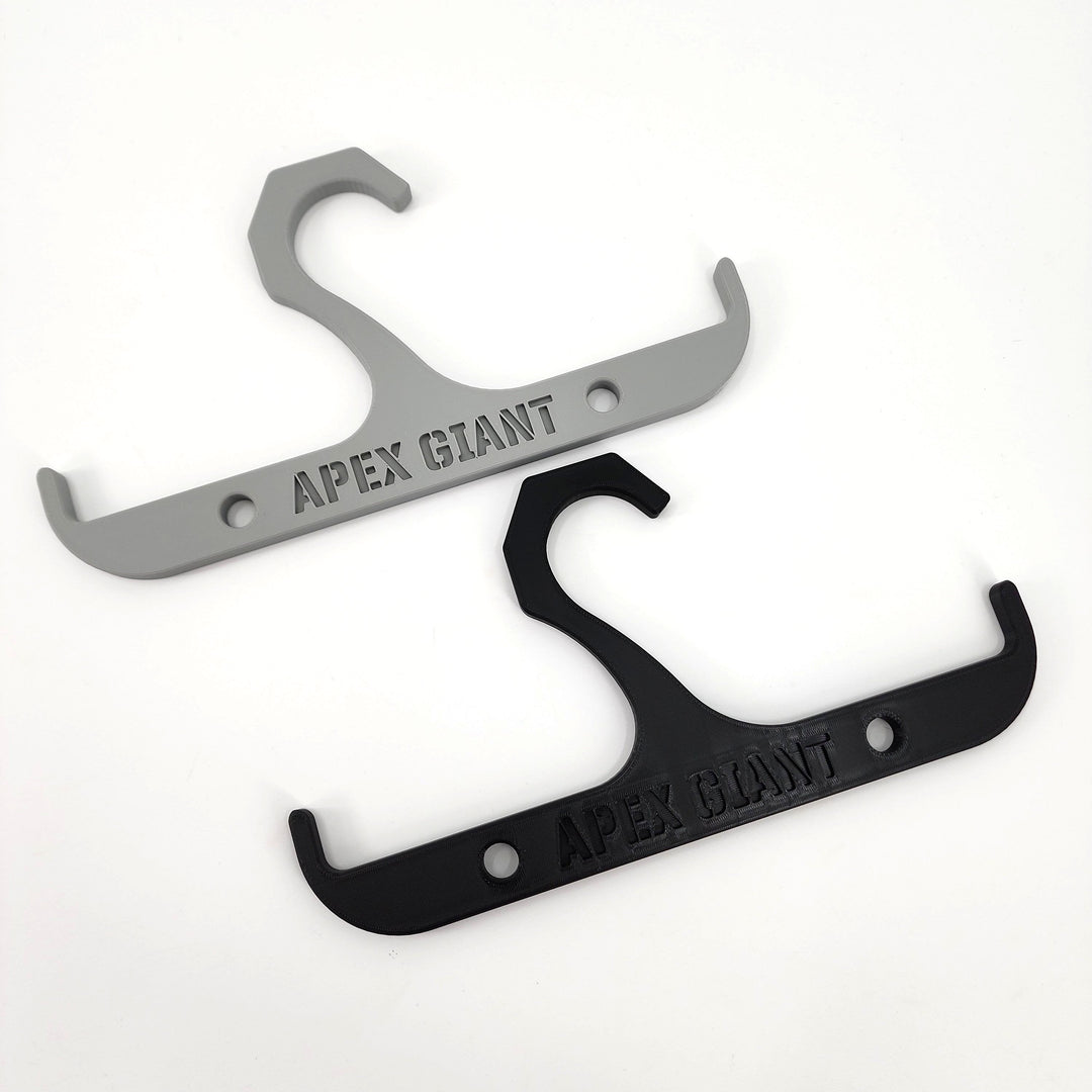 Gray and black backpack hanger with curved hooks and mounting holes