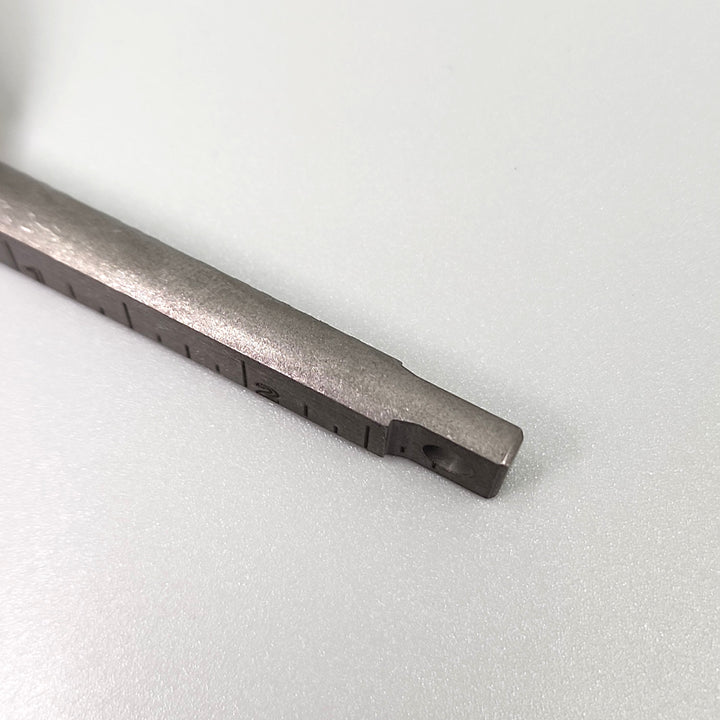 Titanium pry bar keychain tool showing serrated slot and recessed gripping area