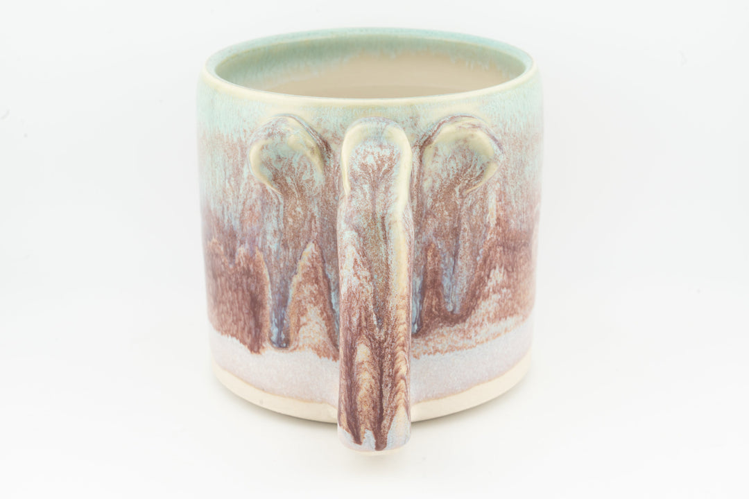 Ceramic mug with mint rim and vertical drip design, sculpted handle