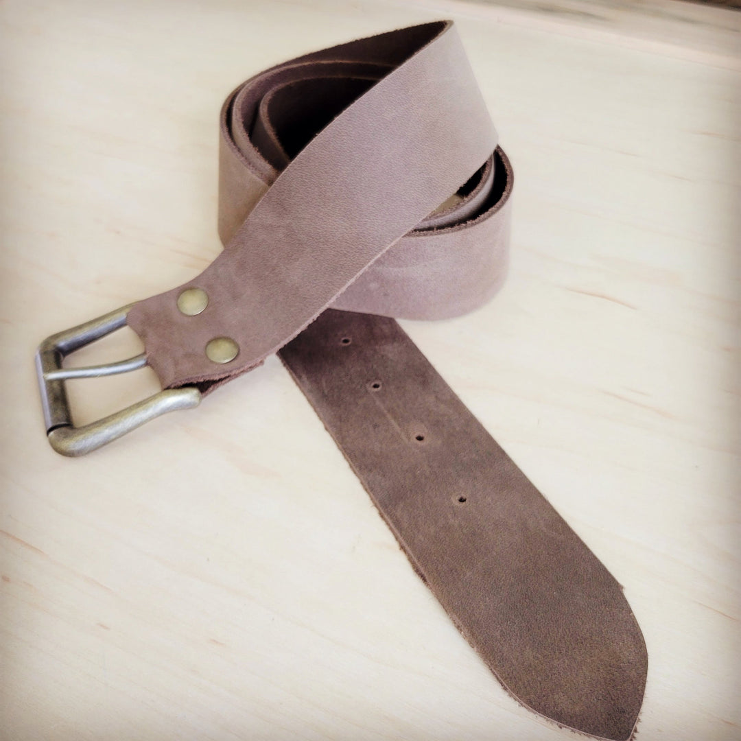 Distressed brown leather belt with silver buckle and eyelet holes, angled view