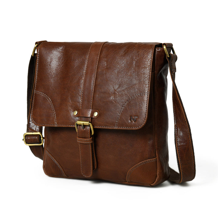 Brown leather unisex sling bag with flap and adjustable shoulder strap