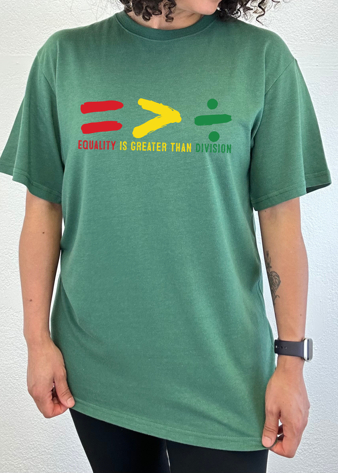Green unisex crew-neck T-shirt with multicolor equality graphic and slogan.