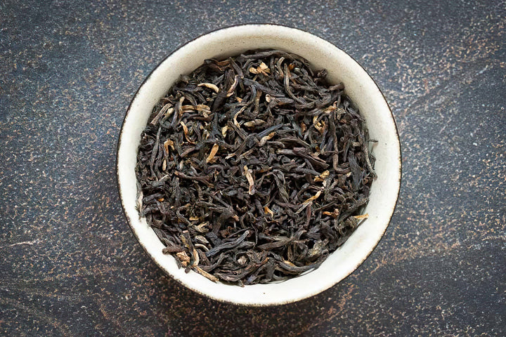 Loose-leaf Jorhat Assam black tea leaves in a bowl