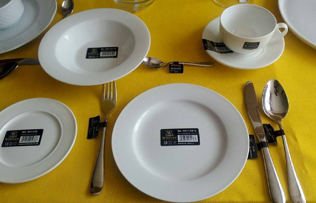 White 10 inch dinner plates set, top view with cutlery and serving pieces