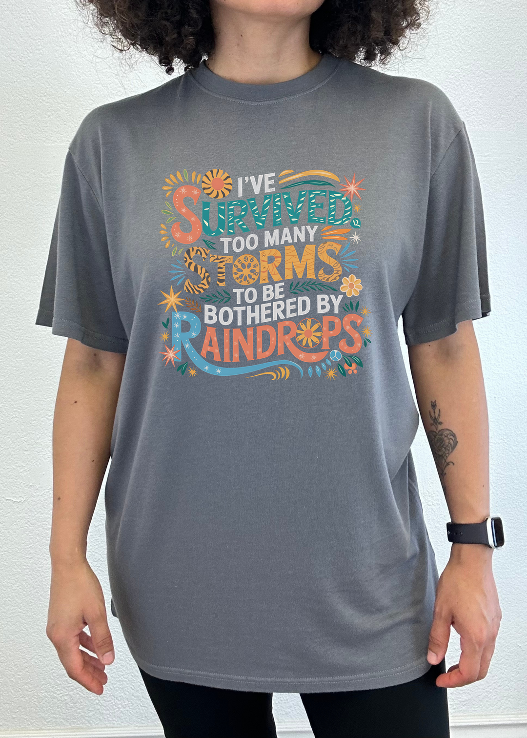Unisex graphic t-shirt, charcoal gray, colorful storm-themed front print.