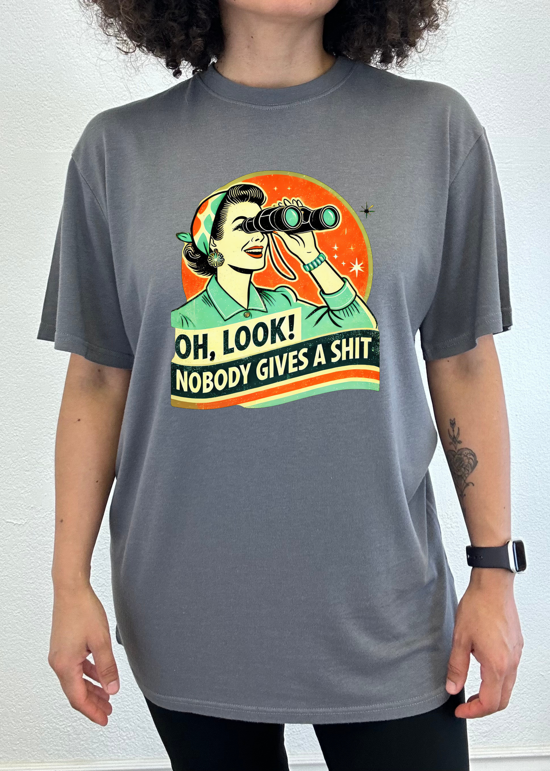 Dark gray unisex graphic T-shirt with retro woman holding binoculars.