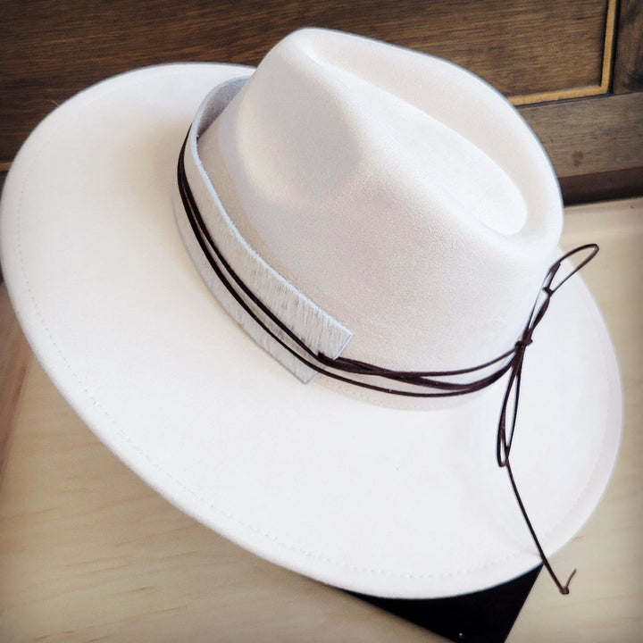 White felt hat with dark band and hanging cord on side