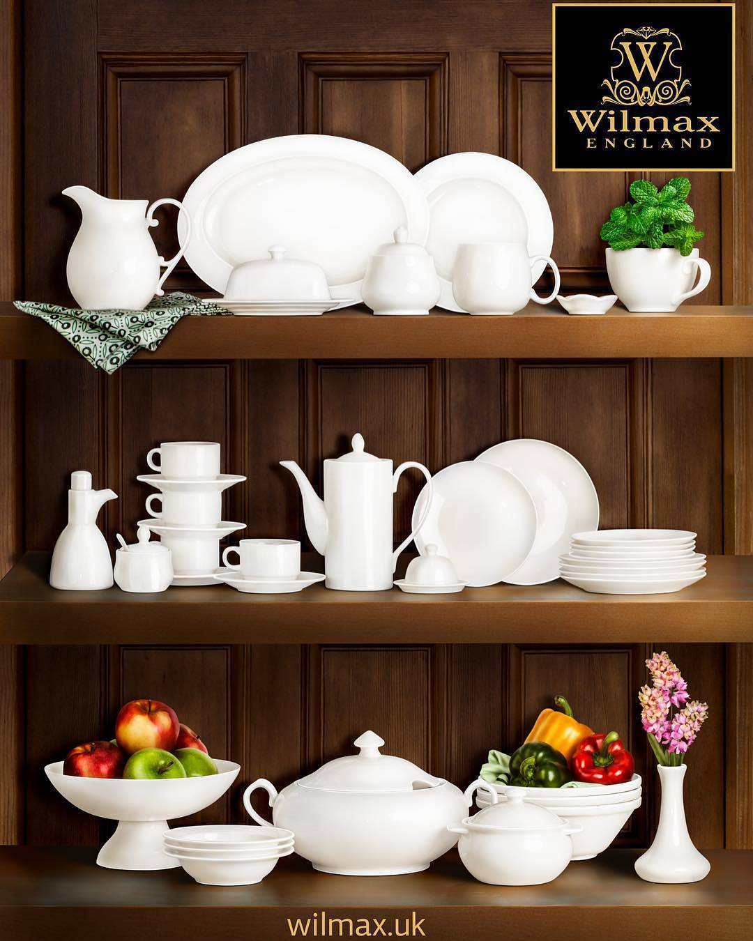 Set of white 8-inch rolled-rim dessert plates on a display shelf, shallow rounds.