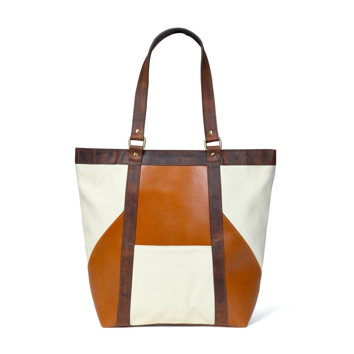 Two-tone leather tote with brown top handles and geometric patchwork panels