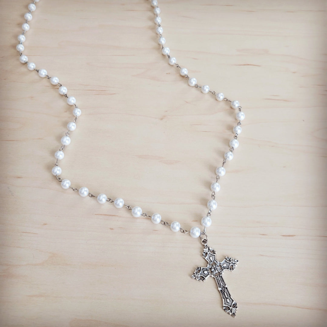 Long pearl beaded necklace with antique silver cross pendant