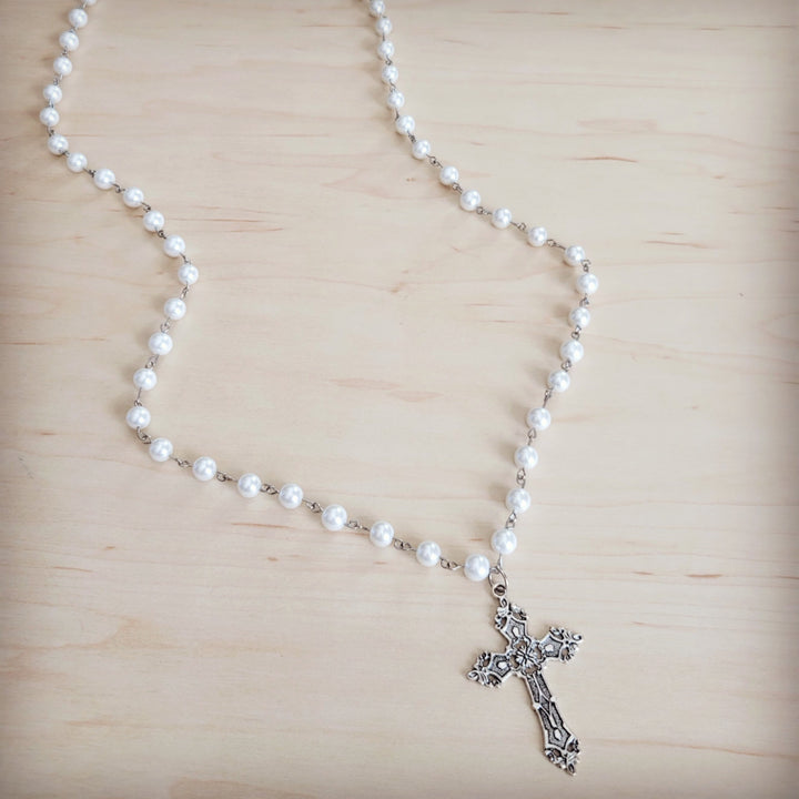 Long pearl beaded necklace with antique silver cross pendant