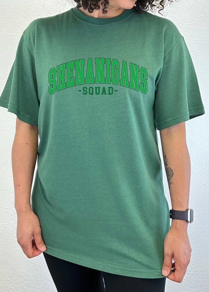 Unisex graphic T-shirt, green with green “Shenanigans Squad” logo on front.