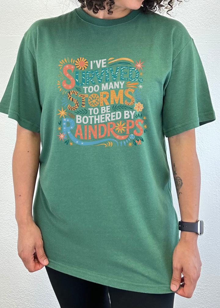 Unisex graphic t-shirt, deep green, colorful storm-themed front print.