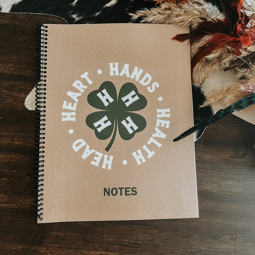 4-H lined spiral notebook, white cover with green round 4-H emblem and NOTES label