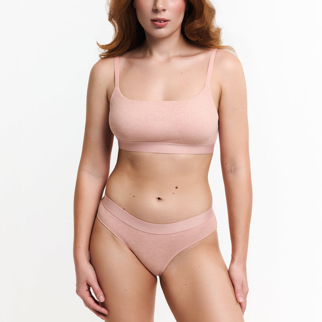 Peach mid-rise brief with smooth bikini cut and high leg openings