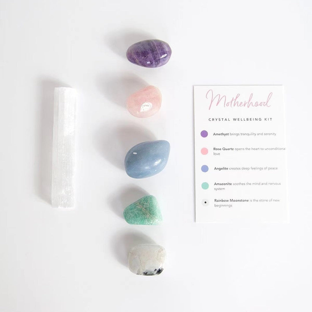 Crystal healing kit with white selenite wand, purple and blue stones, plus instructions card.