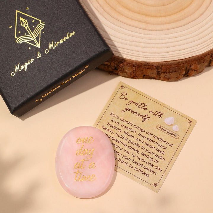 Light pink oval pocket crystal stone with gold “one day at a time” text