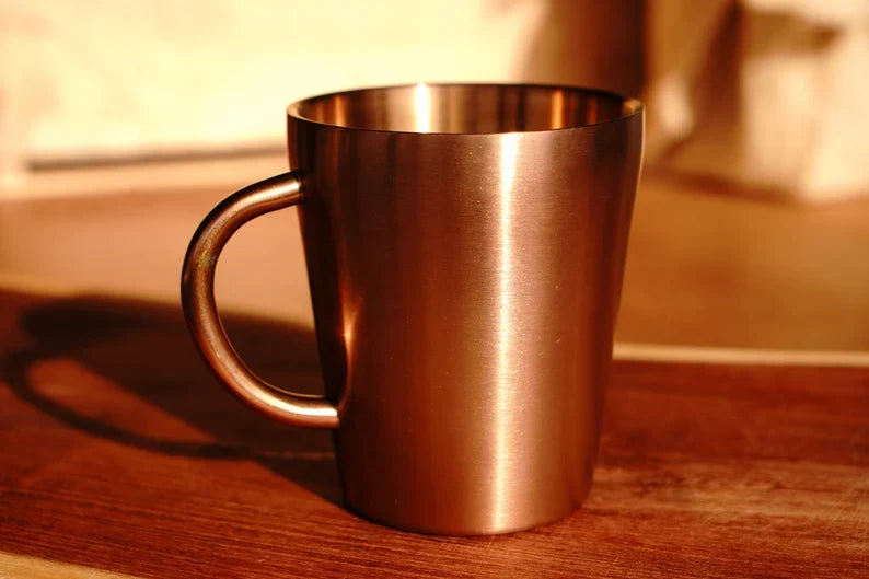 Copper double wall stainless steel mug with handle, viewed from the side