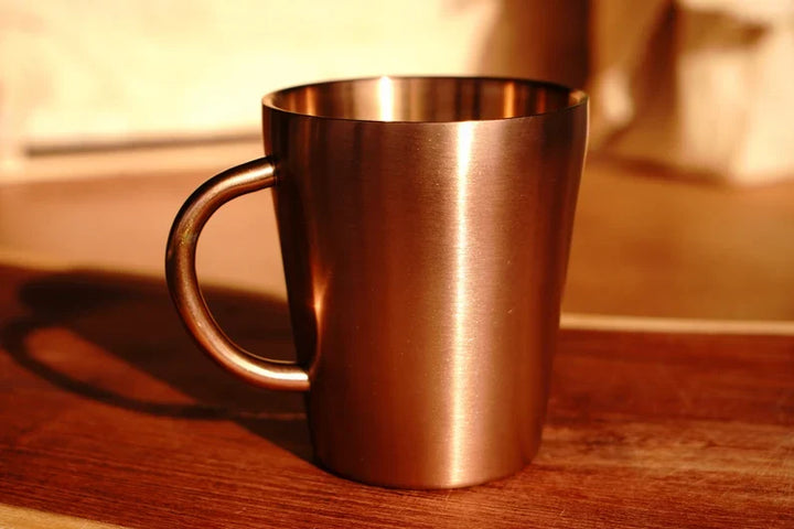 Copper double wall stainless steel mug with handle, viewed from the side