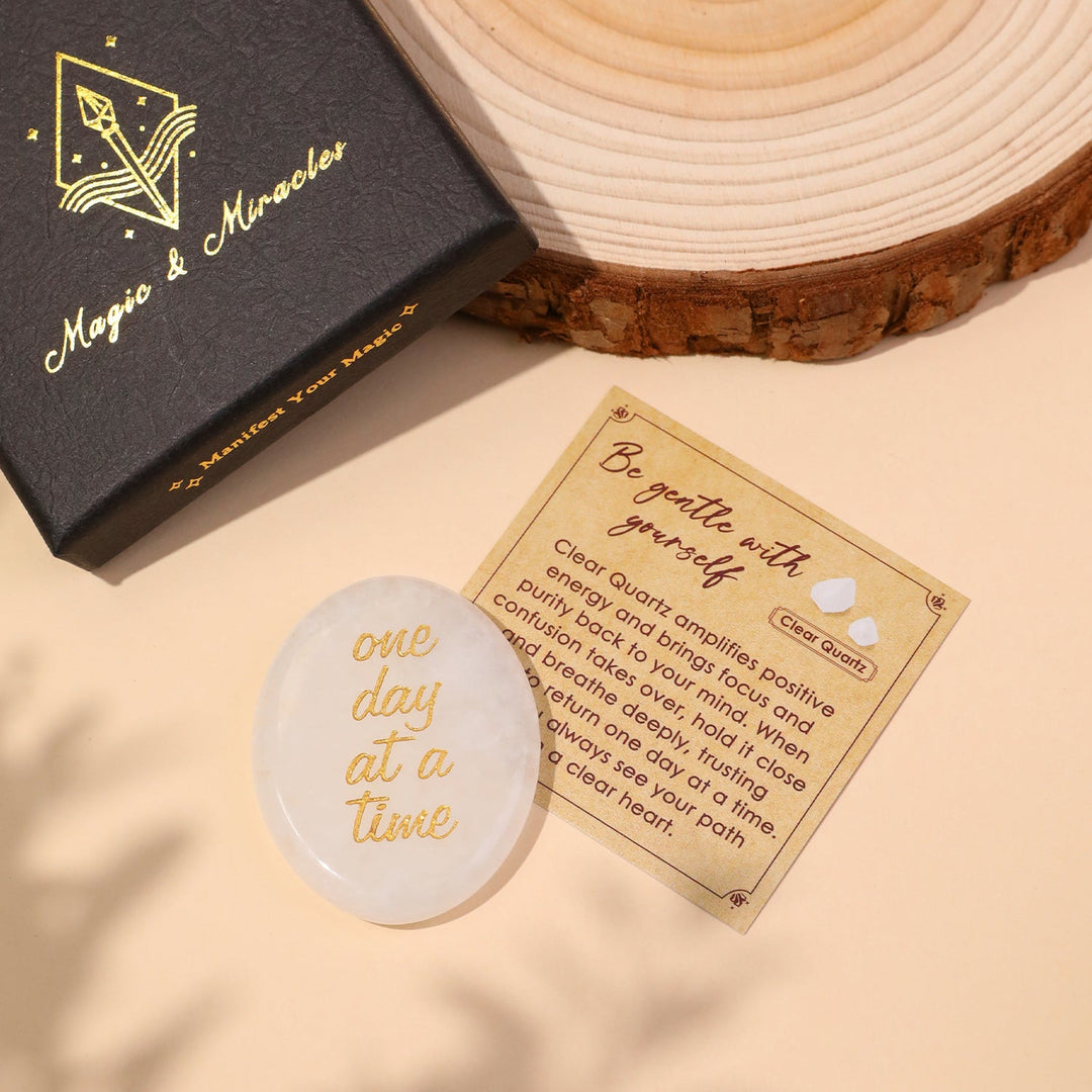 White clear oval pocket crystal stone with gold “one day at a time” text