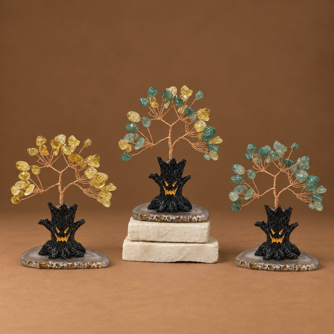 Halloween crystal tree sculpture with yellow and teal gemstone branches on black base